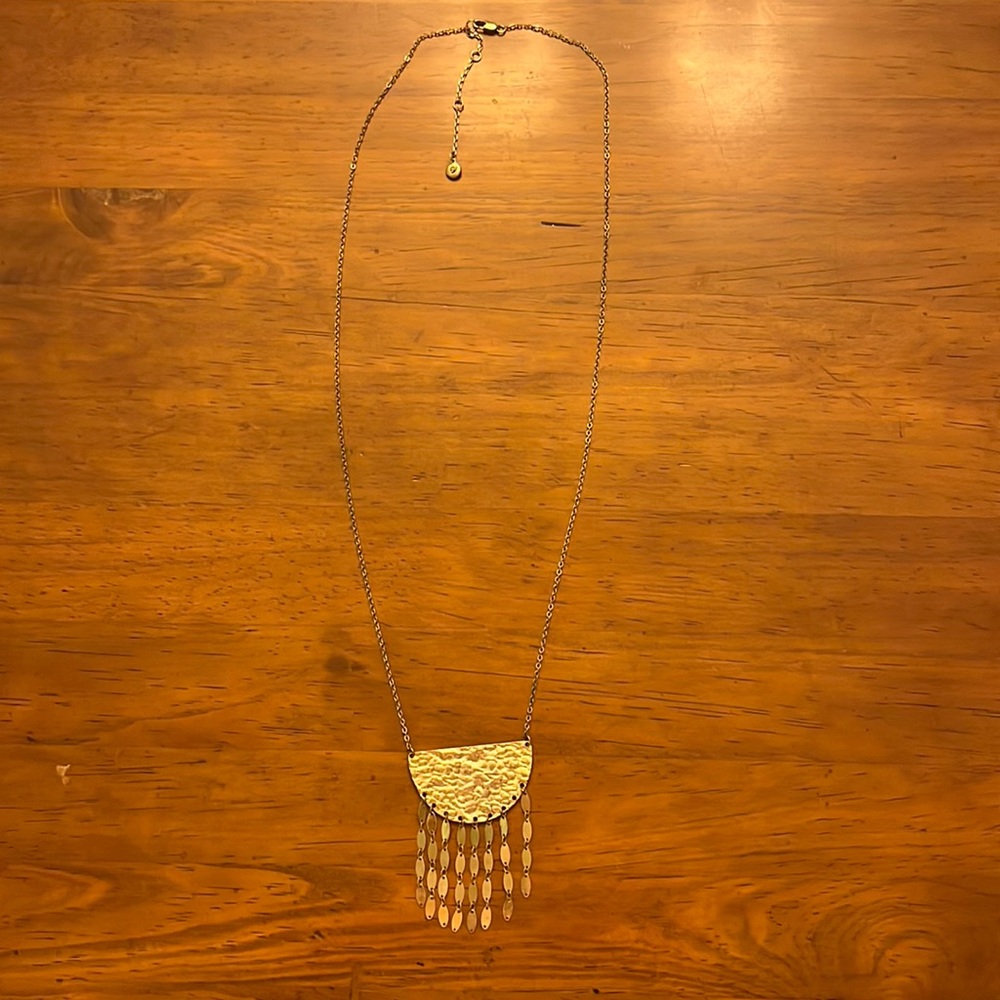 Gold colored  necklace with hammered metal plate and tassels